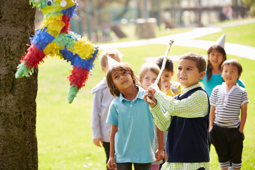 Children Hitting Pinata At Birthday Party