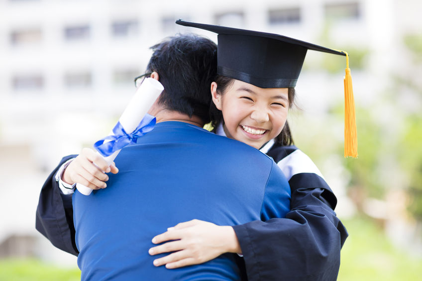 female student and family hug celebrating 